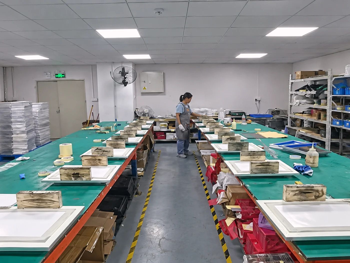 The HanKe stencil workshop in Zhongshan: assembly benches and laser cutting machines